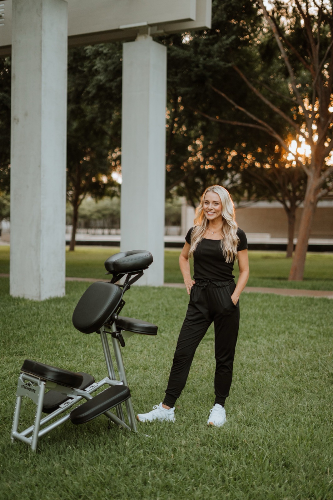 Emily Kaellner, Licensed Massage Therapist, with her portable massage chair in a Dallas–Fort Worth park